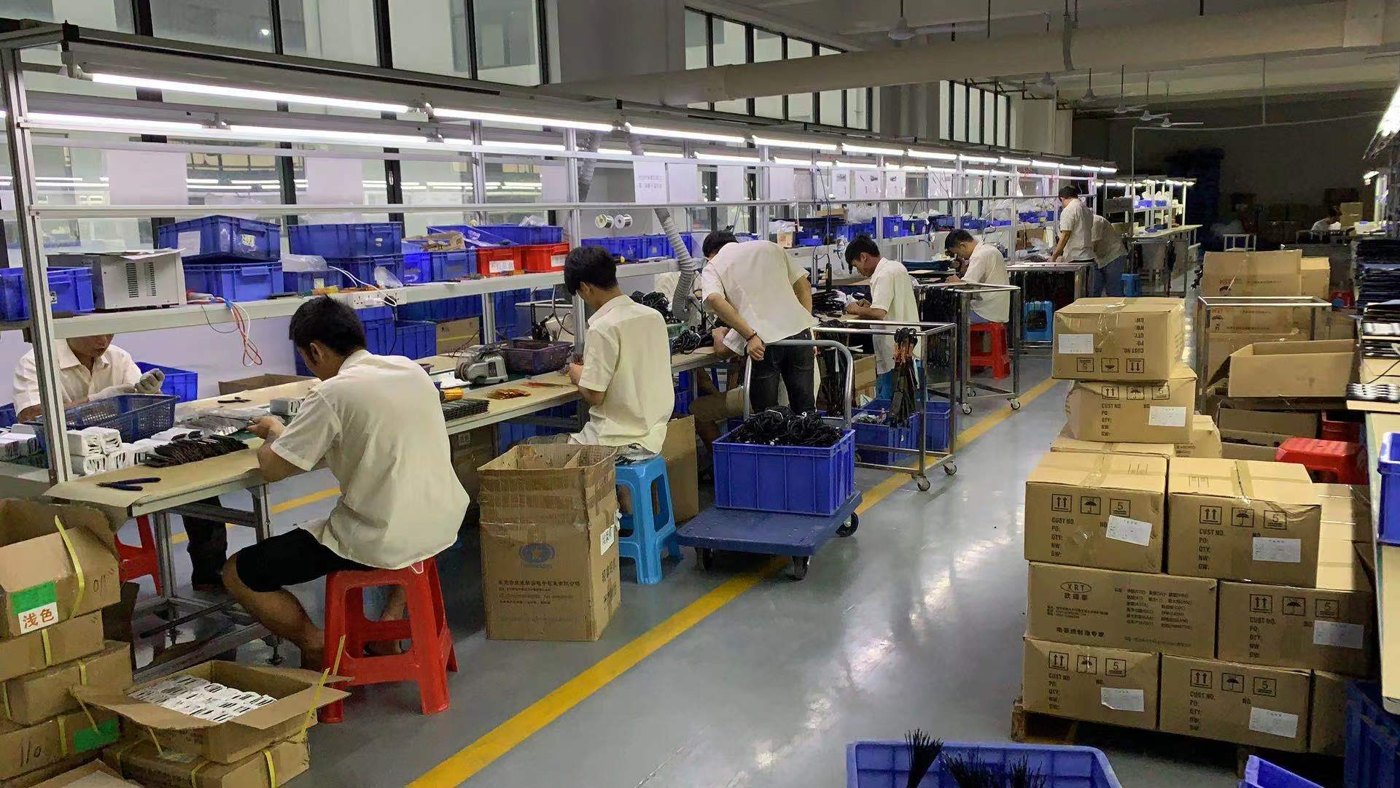 Hair appliance assembly area with production staff and workstations